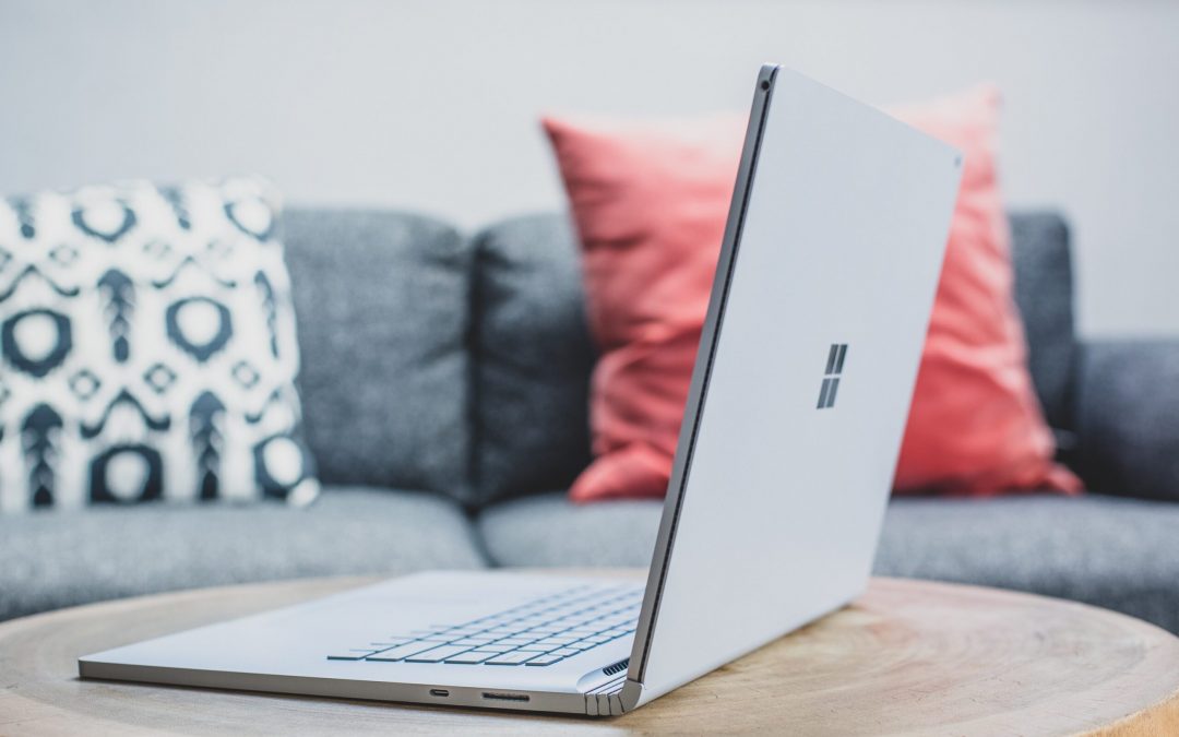 macbook pro on white couch