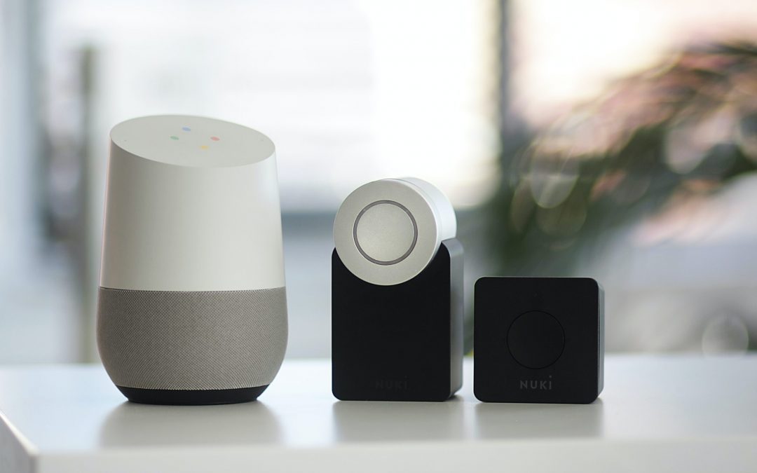 white and gray Google smart speaker and two black speakers