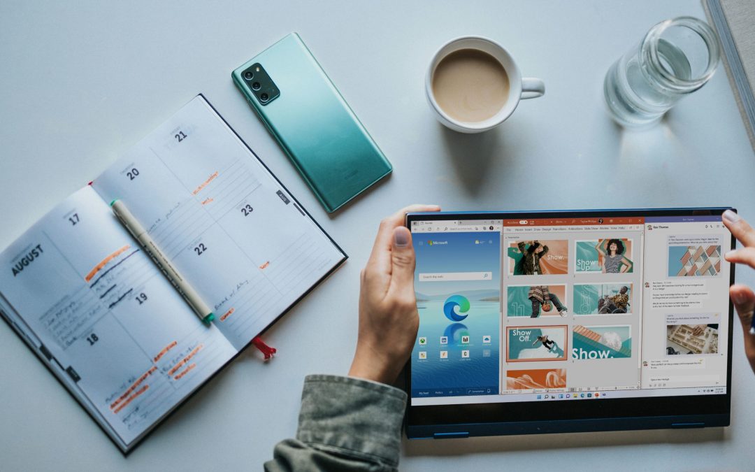person using Windows 11 computer beside white ceramic mug on white table