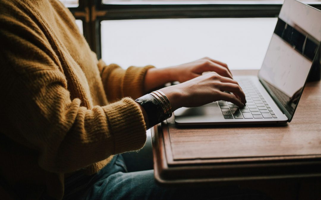 person sitting front of laptop